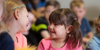 girls smiling at each other